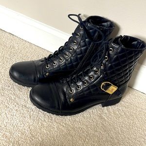 Black guess boots with gold accents